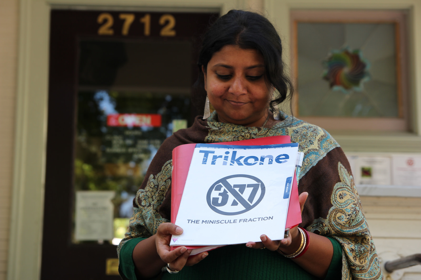 Barnali holds up Trikone’s Newsletter, which features the numbers 377 with a line diagonally crossing it out.