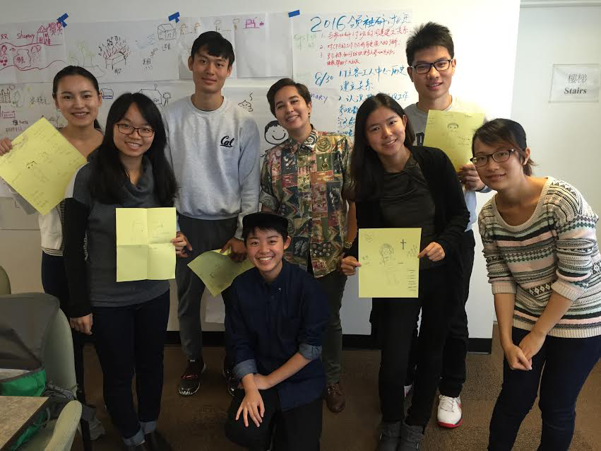 Image Description: 6 Chan Fellows and 2 APIENC staff members take a group photo, while each person holds up yellow pieces of paper.