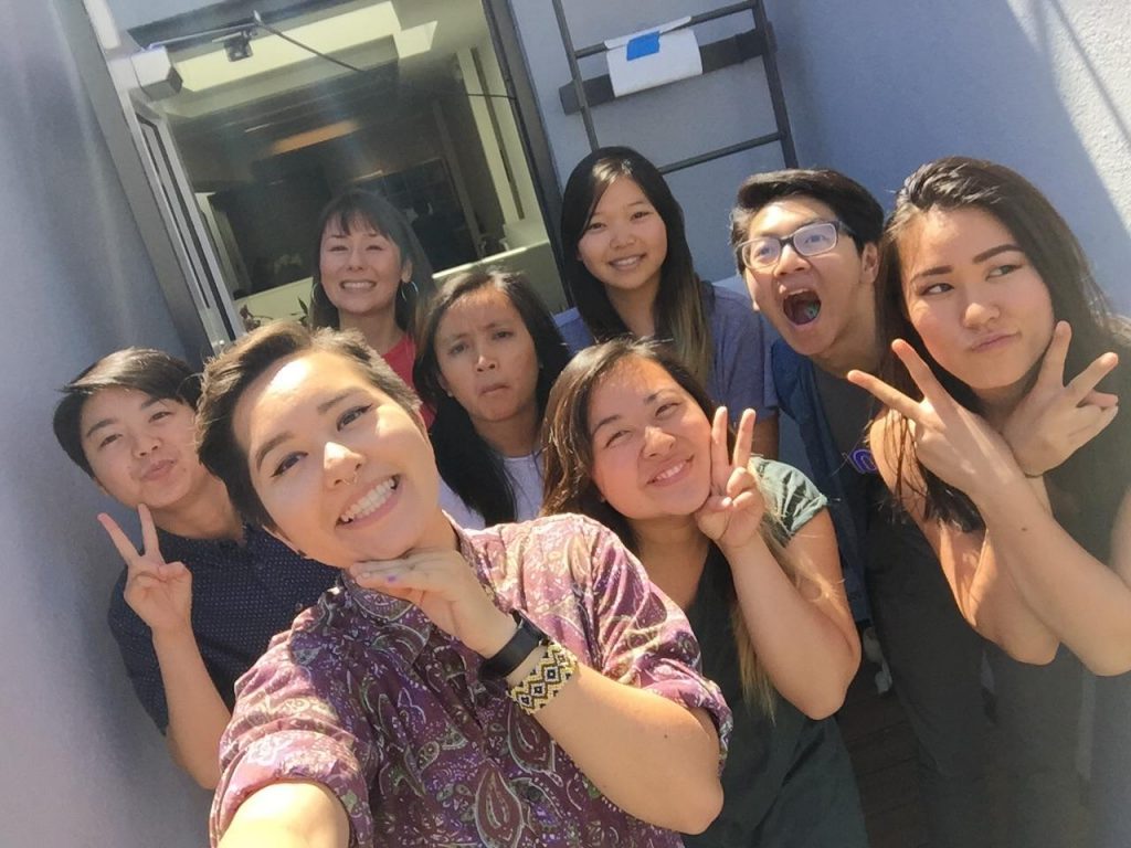 Image description: Six interns and two APIENC staff members take a selfie outside. They are making faces at the camera.
