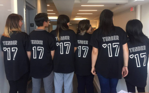 Image description: Six interns have their backs turned towards the camera. Their jerseys read, "Tender '17."